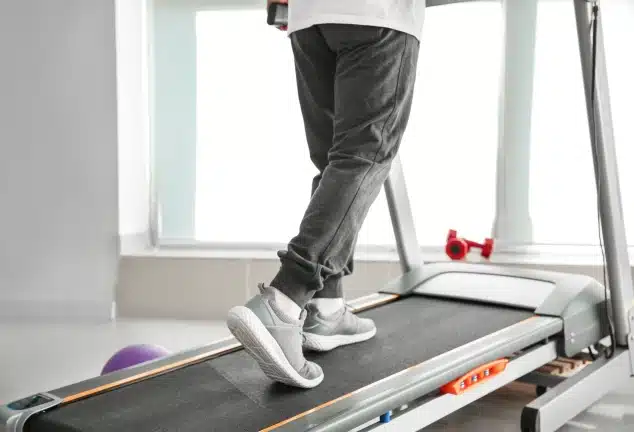 Person walking on a treadmill during cardiopulmonary rehabilitation