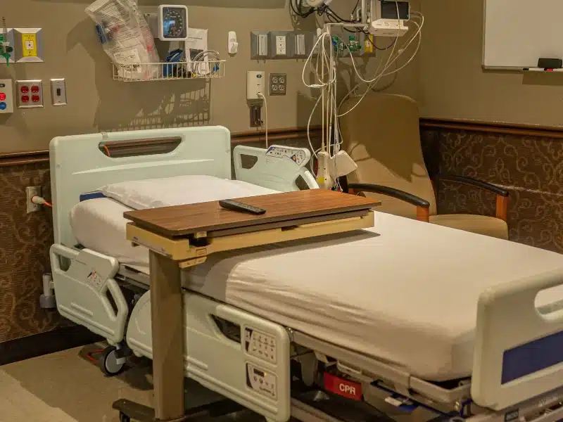 Inpatient hospital room with bed and over-bed table