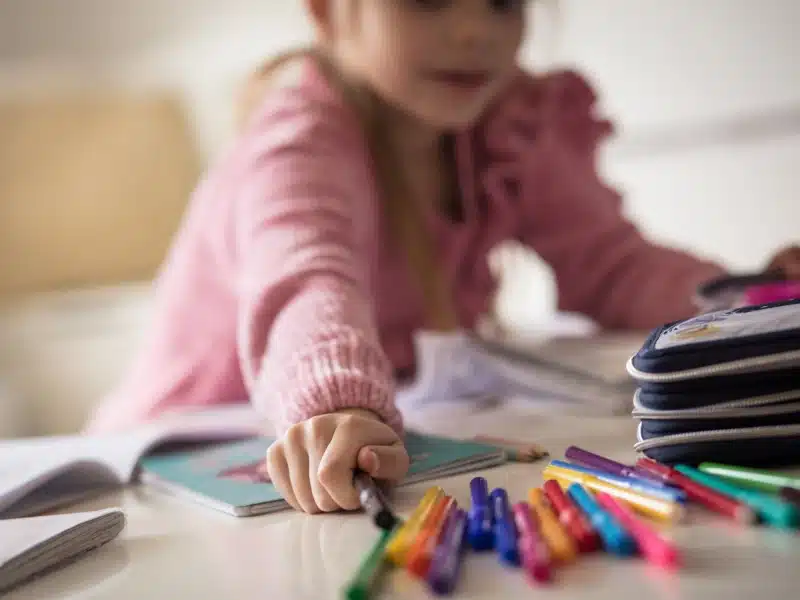 Child coloring with markers, supported by the Smiles From Jamie fund
